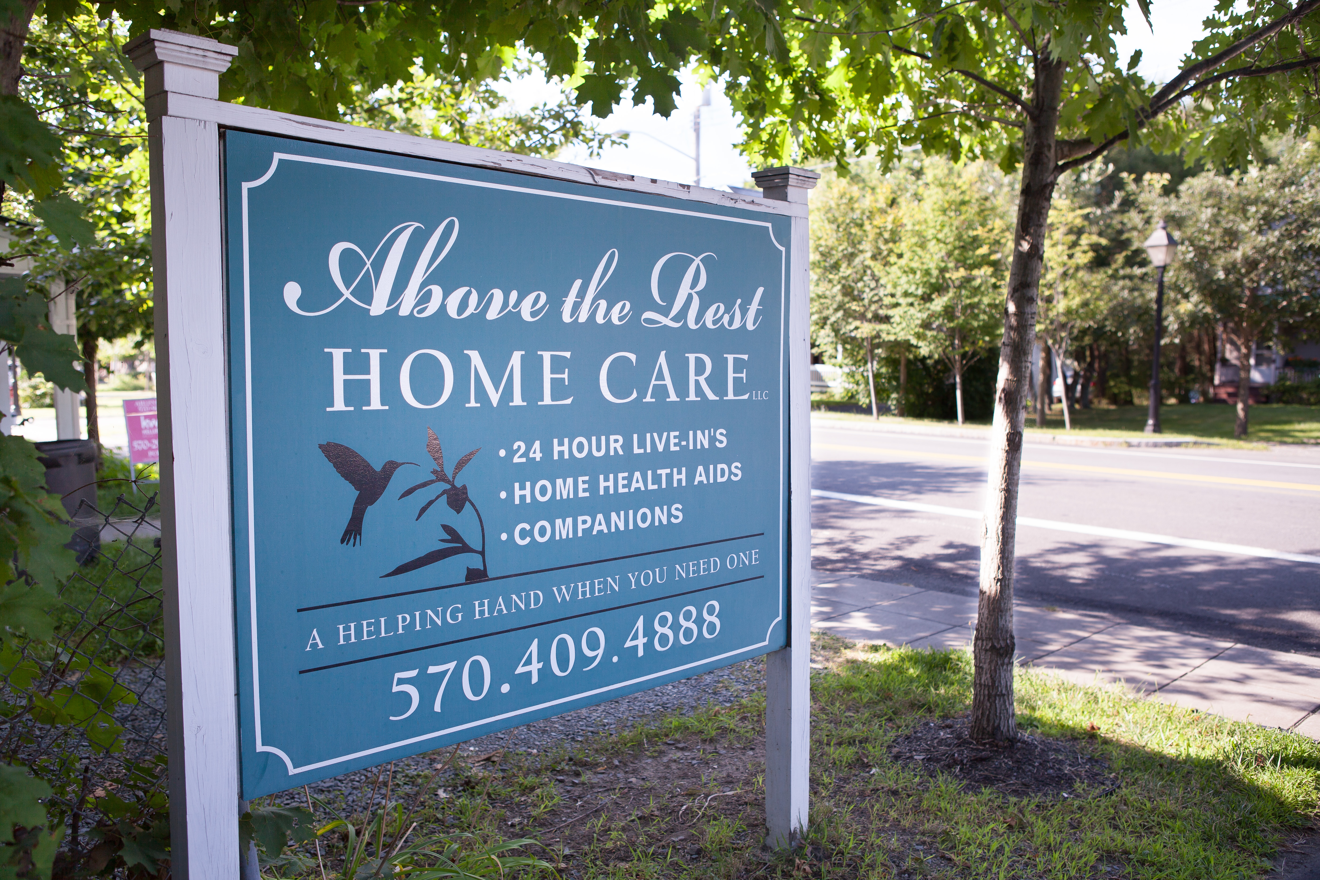 A caregiver holding the hand of an elderly client